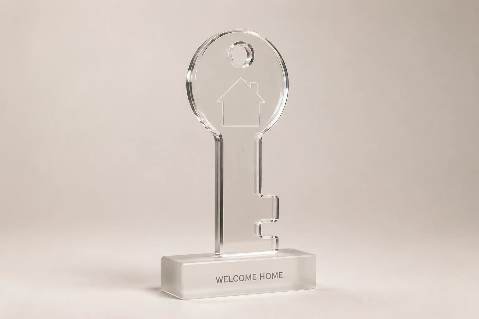 Polished clear acrylic house-key award on a frosted base.